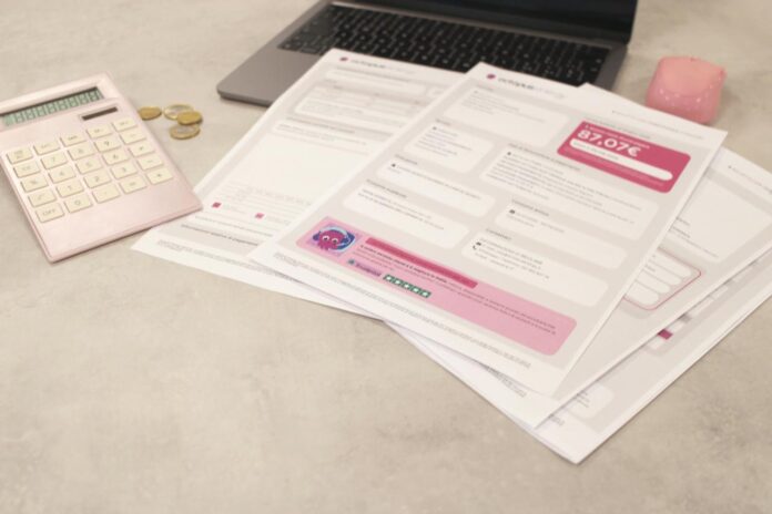 Tagihan dan kalkulator duduk di atas meja.